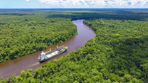 A ship going down a river.