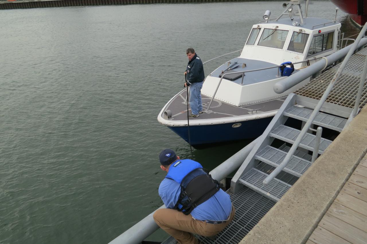 USMMA Instructors, Rich Cain (foreground) and Chris Gasiorek, tie up one of USMMA's small boats at the pier in Staten Island to visit SS Wright and T/S Kennnedy on December 5, 2012. Photo Credit: Barbara Voulgaris