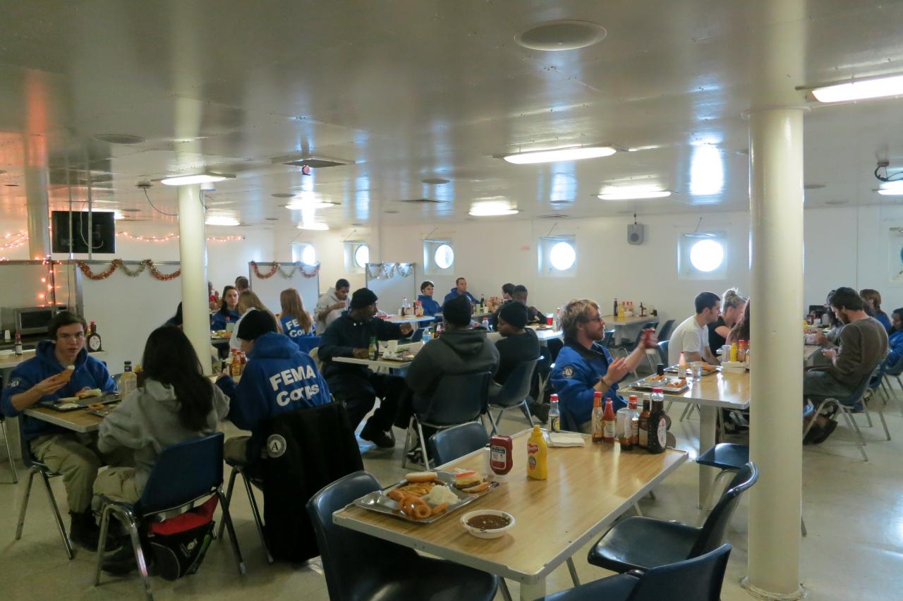 FEMA Corps volunteers, Wright crew members, and other volunteers have lunch onboard SS Wright on December 5, 2012. Photo Credit: Barbara Voulgaris