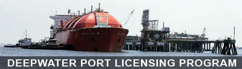 Orange vessel docked at a port.